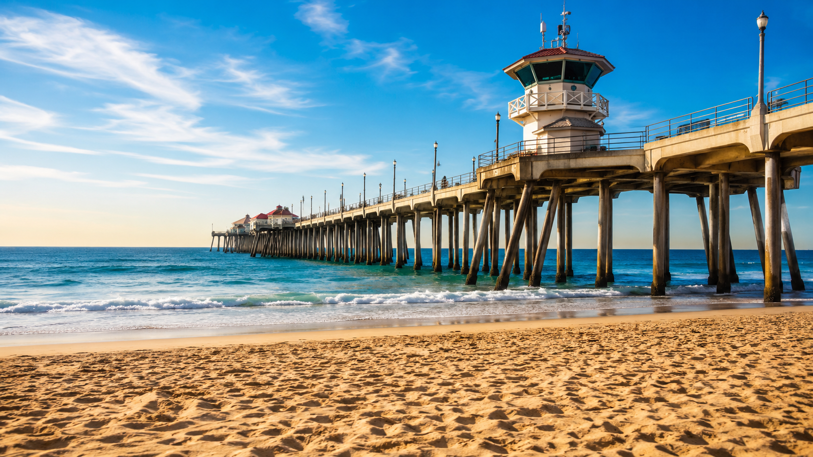 Surfers at the Huntington Beach Pier at golden hour